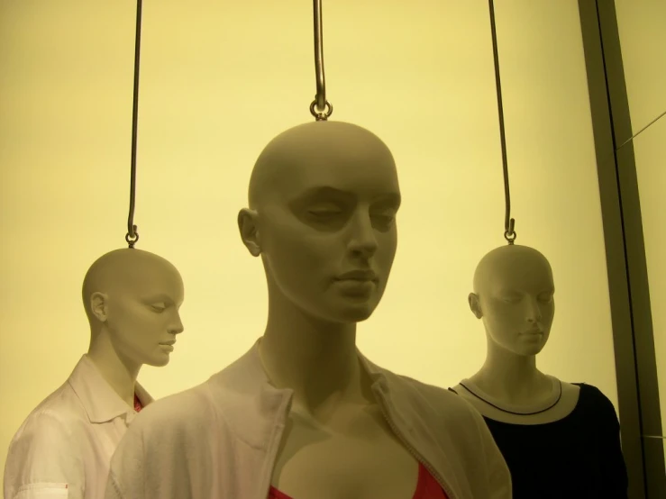 mannequins hanging up with their heads covered