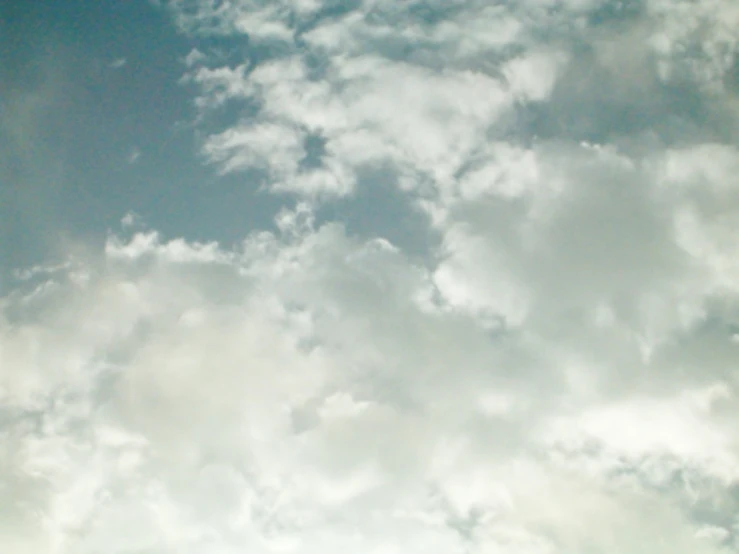 a picture taken from the ground looking up at some clouds