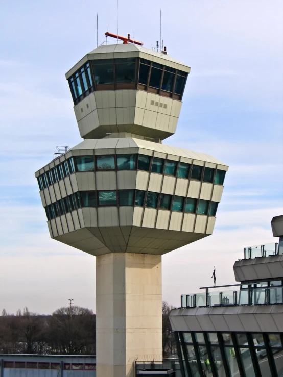 the control tower is built in a tower with multiple windows