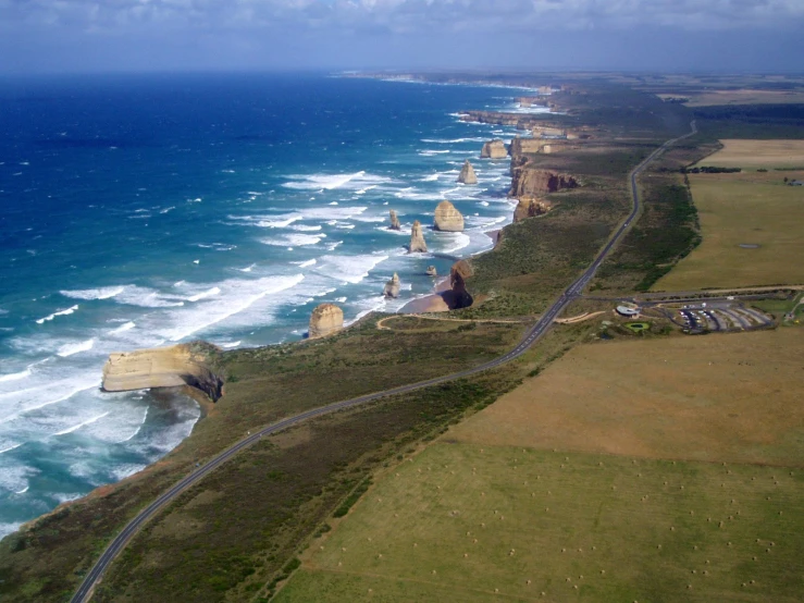 a scenic view of a grassy hill and ocean