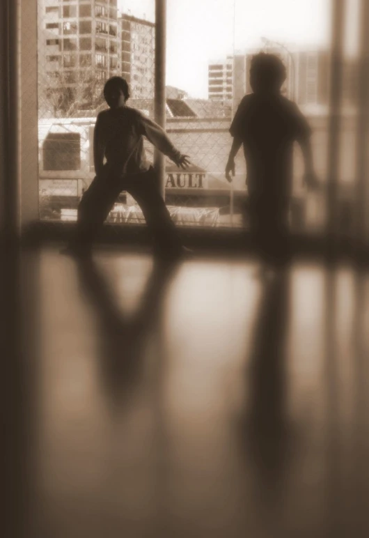 two children looking out a window and a train on the track