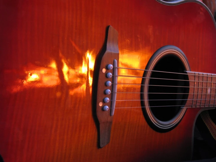 an image of an acoustic guitar in the shadows