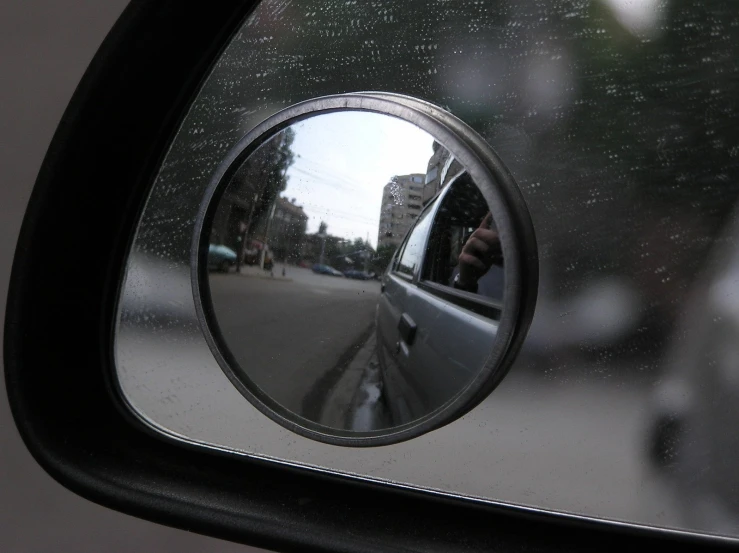 a side view mirror of a vehicle on the street