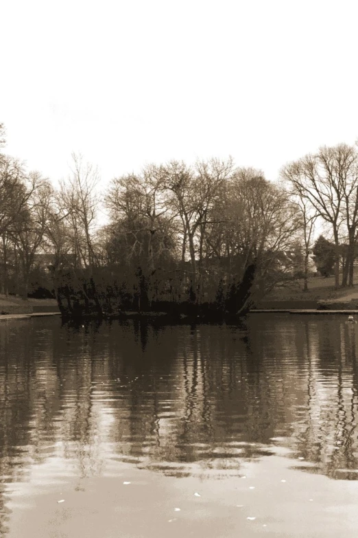 an old boat in the water in a park