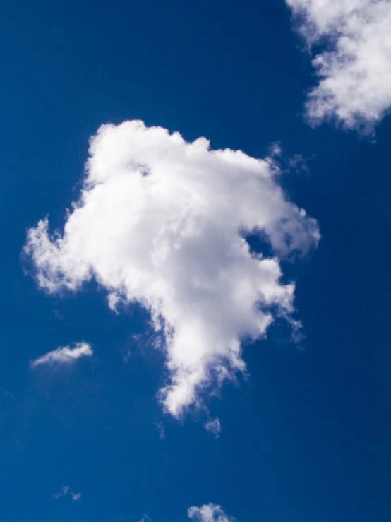 a plane flying in a partly cloudy sky