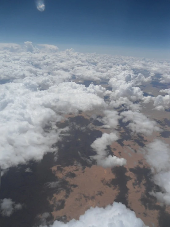 view out the airplane window at clouds and sky