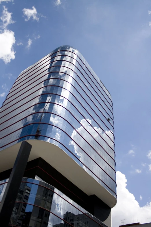 a tall building with many windows sitting in front of a blue sky