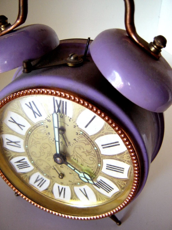 an antique clock that has been painted purple