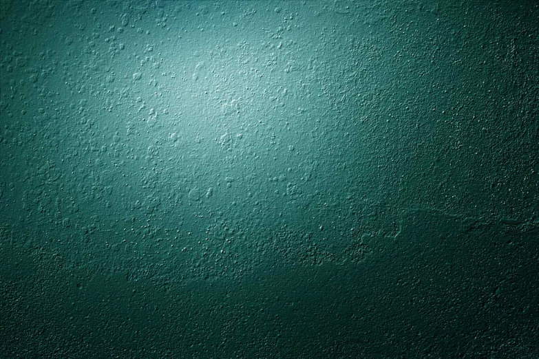 a green textured wall or background with light reflection