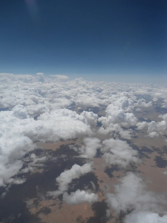 the clouds below are so fluffy and fluffy