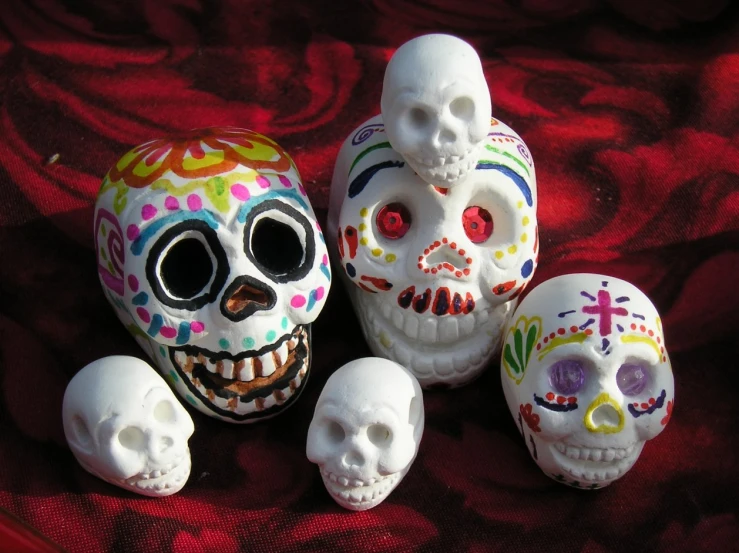 a couple of different colored skull shaped items