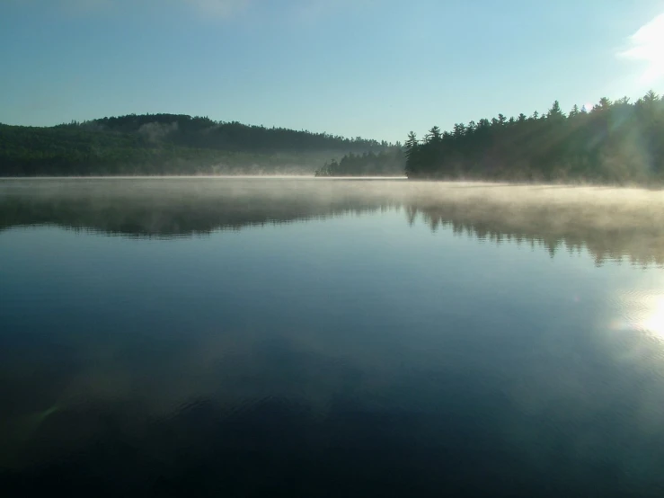 a view from a boat on a misty lake