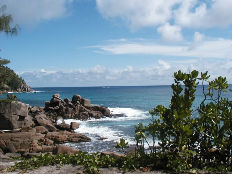 waves come ashore on rocks beside the ocean