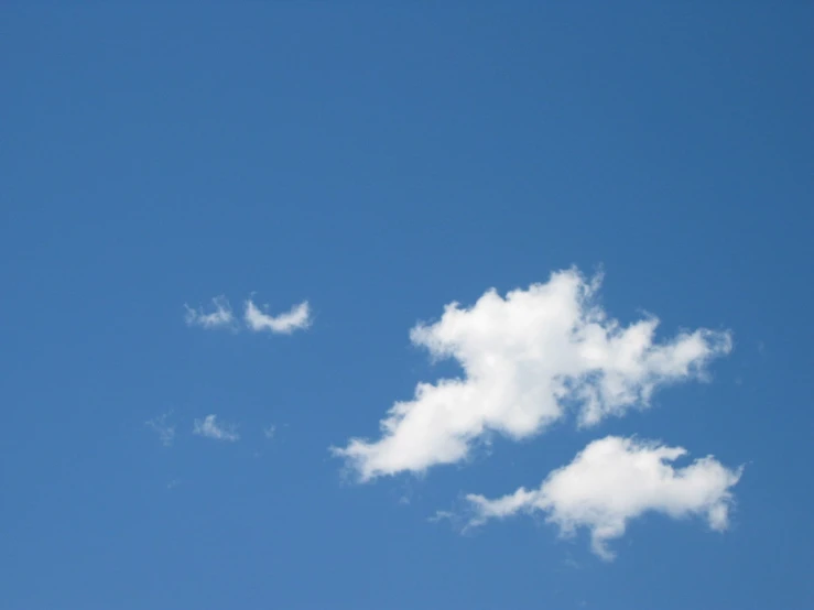 two white clouds are forming and flying in the sky