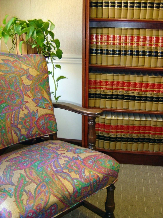 this is an upholstered colorful office chair in front of a book shelf
