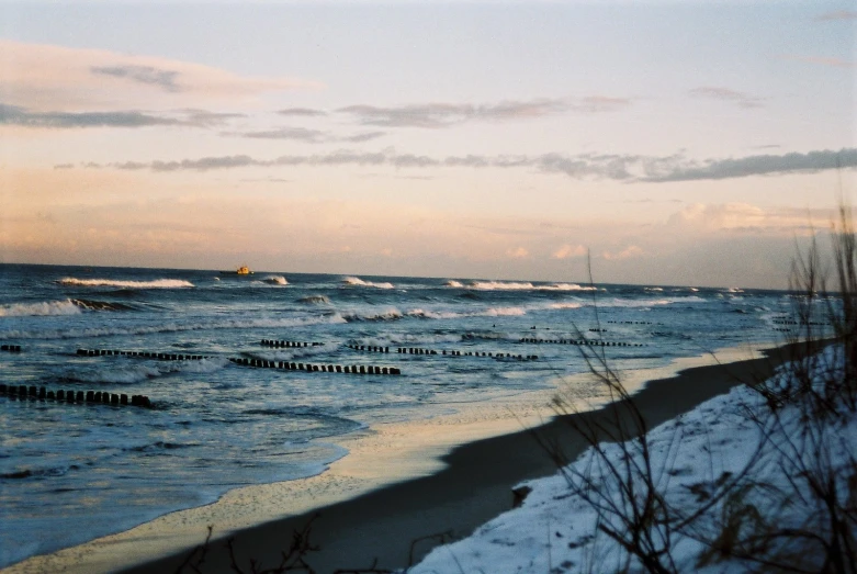 waves with small skis in the foreground at sunset