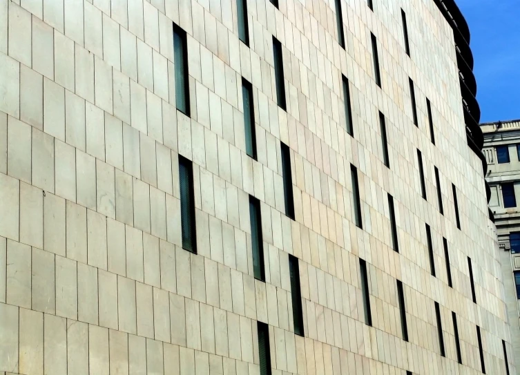 the view of an intersection and building, taken through a plane window