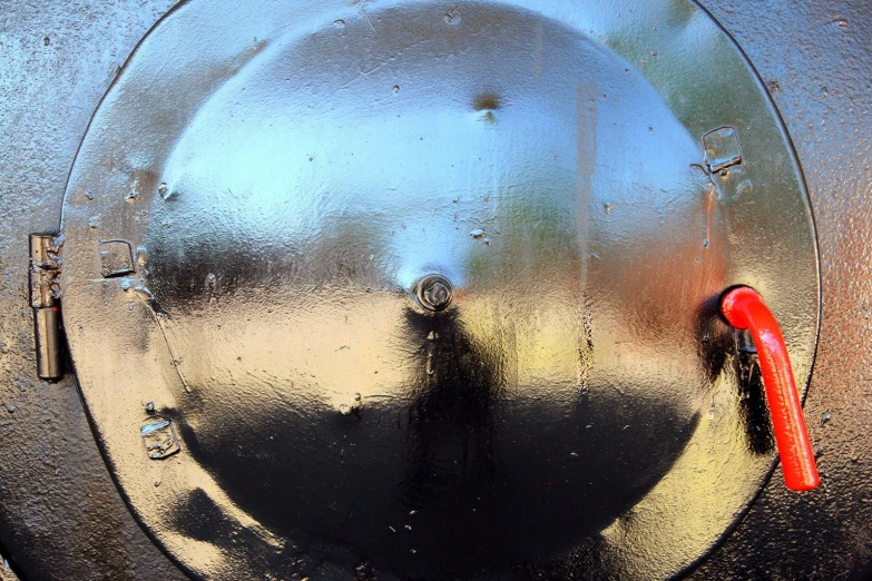 the handle of an electric meter on a metal surface