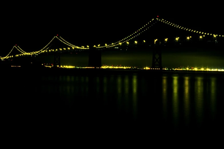 the bay bridge lit up at night