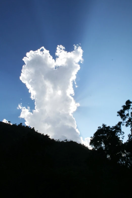 there is a cloud coming out of a mountain