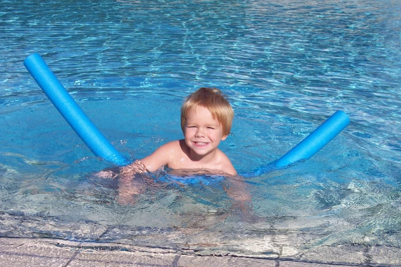 a  in the pool has two giant tubes for playing