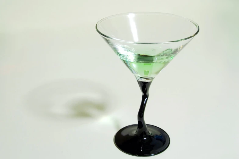 a martini glass filled with lime liquor