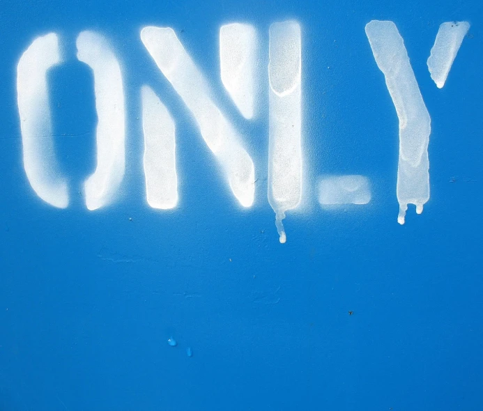 a blue wall with the word only spray painted in white
