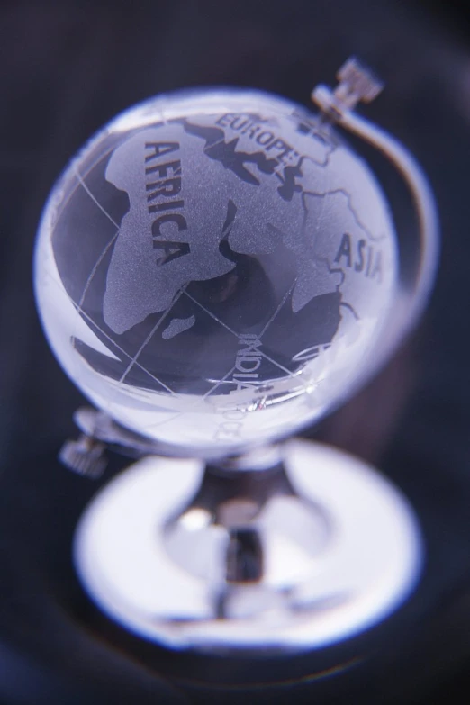 a glass globe with a small hole in the center and a map around it