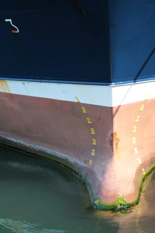 an orange and blue boat docked at a pier