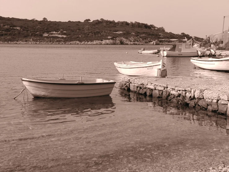 a black and white po of a dock with several boats