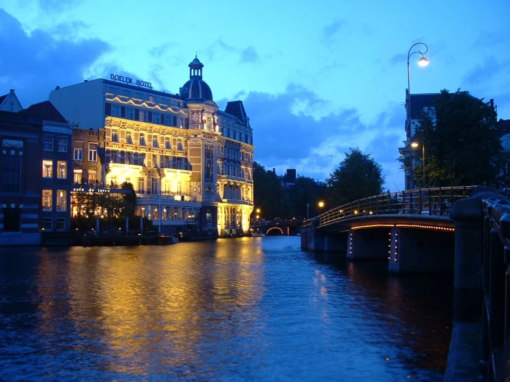 a long exposure s taken at night shows a canal and buildings