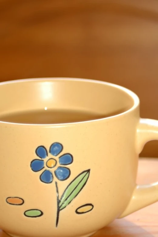 there is a mug with a flower painted on it