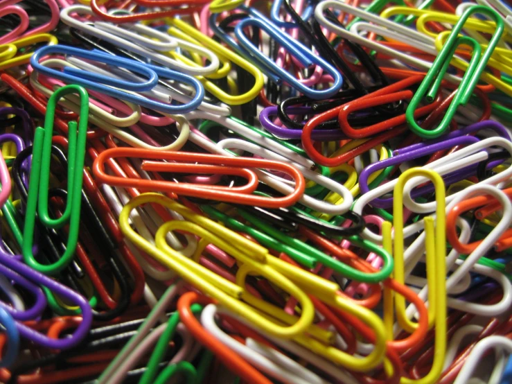 many colored paper clip arranged around each other