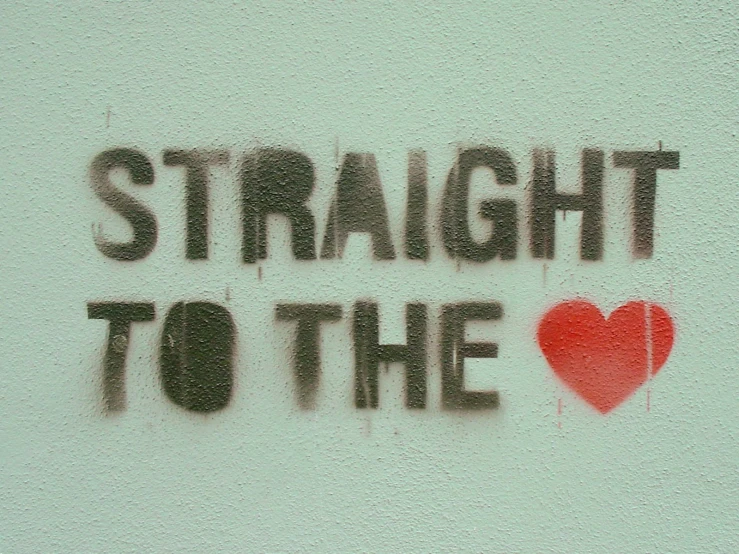 a stencil writing with a heart is shown