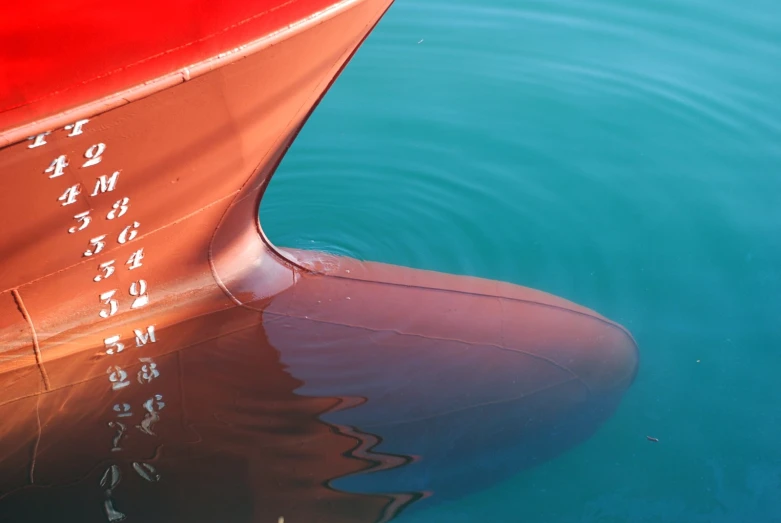 closeup of the back end of a boat in a body of water