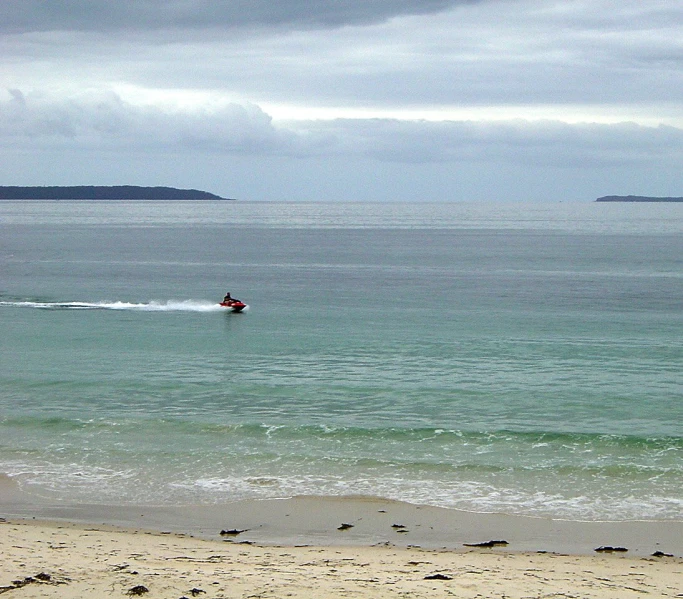 the man is wind surfing on the water