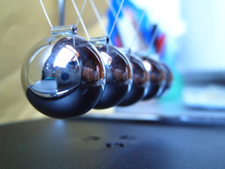 three ornaments are hanging on a line from a wall