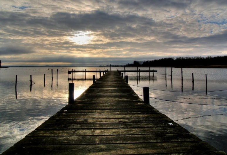 a long dock sitting in the middle of a lake