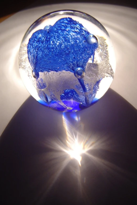 an image of a blue glass object in the sun