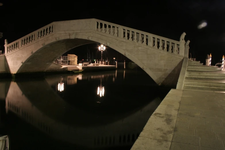 there is a bridge that crosses the river at night