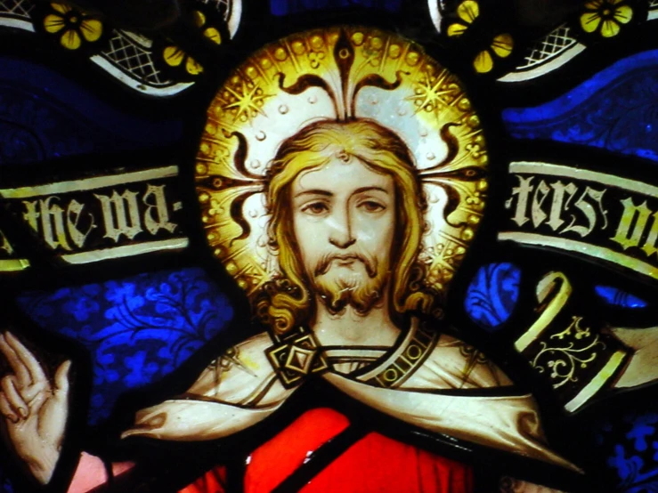 a stained glass window with jesus wearing a crown