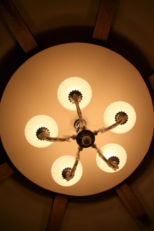 the overhead lamps are arranged around four circular lights