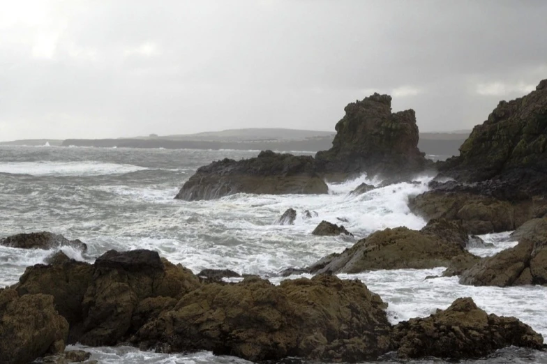 a rock shoreline with large rocks near it