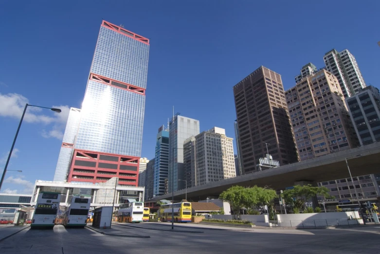 buildings in a city with a bus driving by