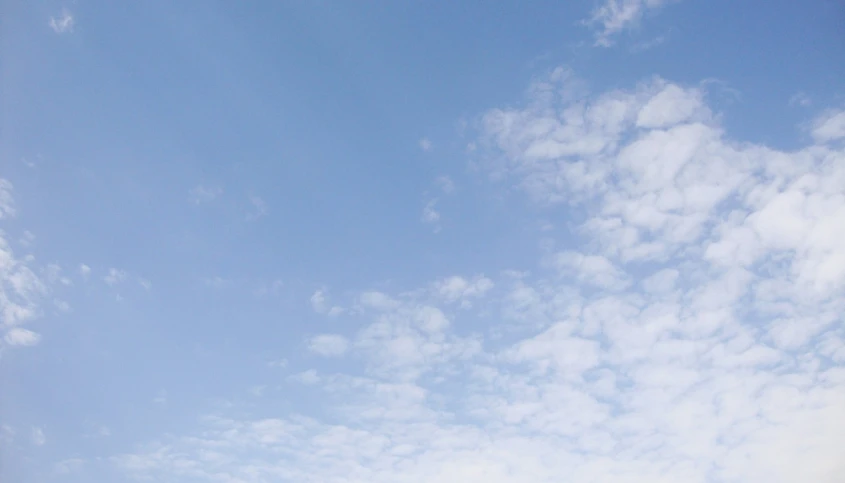 a large kite in the sky above some buildings