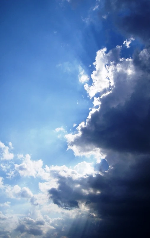 a large kite flying in the sky with a very blue background