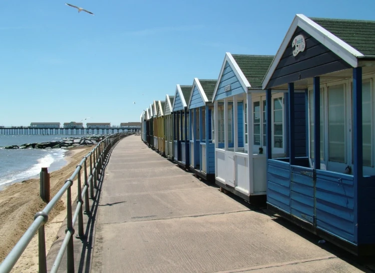 this is a row of beach huts on a boardwalk