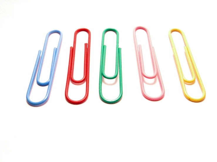 five colors of plastic paper clip with a white background