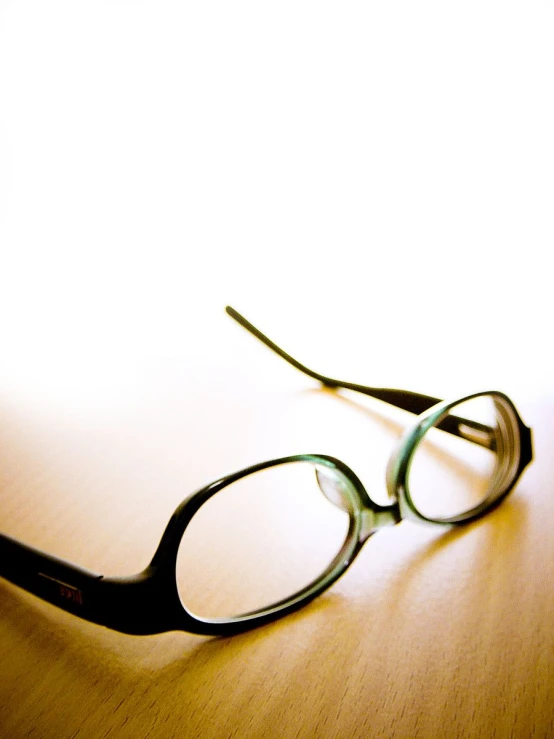 a pair of glasses sitting on a table