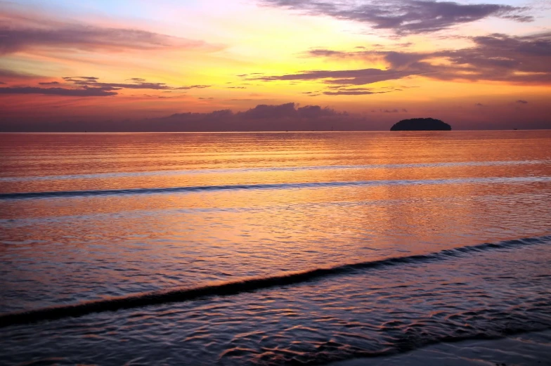 sunset over the ocean on a cloudy day